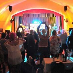 Crowd dancing and cheering at a STEViE ZiPP concert