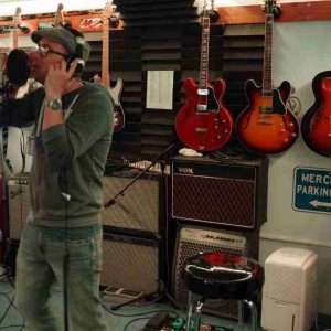 Dan CS Martin singing into a microphone in the studio