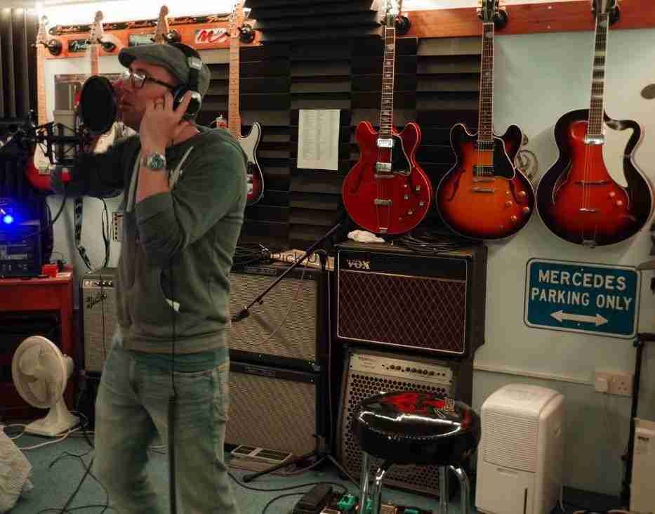 Dan CS Martin singing into a microphone in the studio