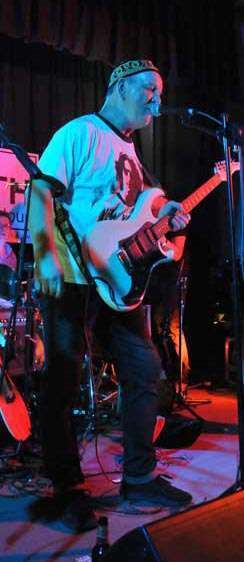 STEViE ZiPP performing on stage singing into a microphone