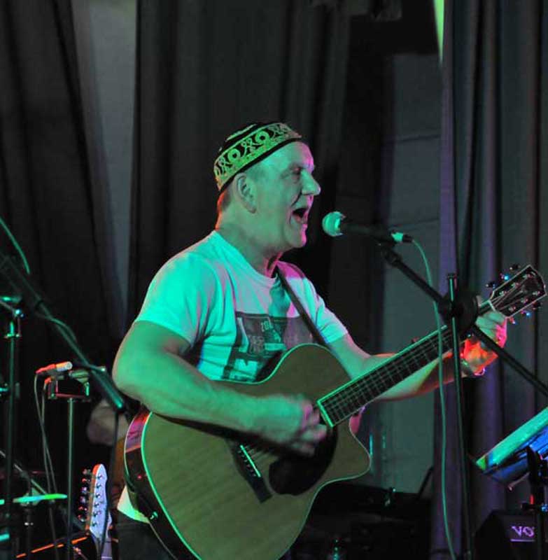 STEViE ZiPP singing-on-stage wearing a fezz