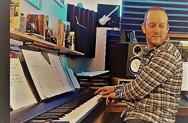 Jacob Allinson playing organ in the recording studio