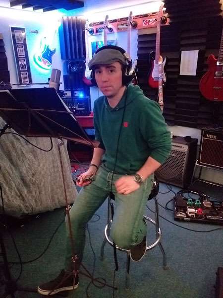 Dan CS Martin sitting in a stool in the studio