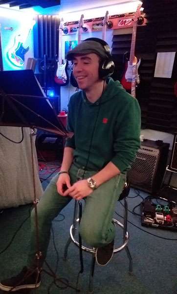Dan CS Martin sitting in a stool in the studio